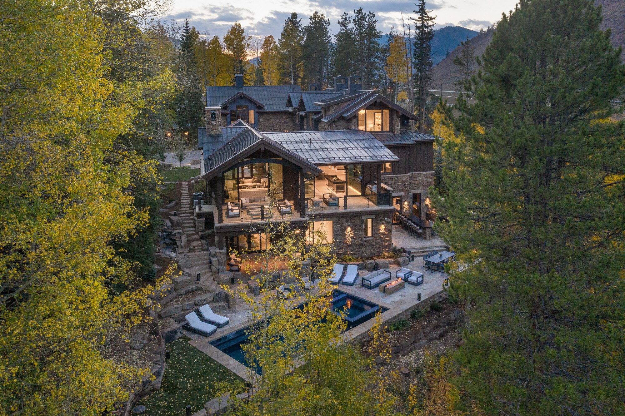 Cabin Circle elevated view at dusk nestled among aspens with mountain backdrop