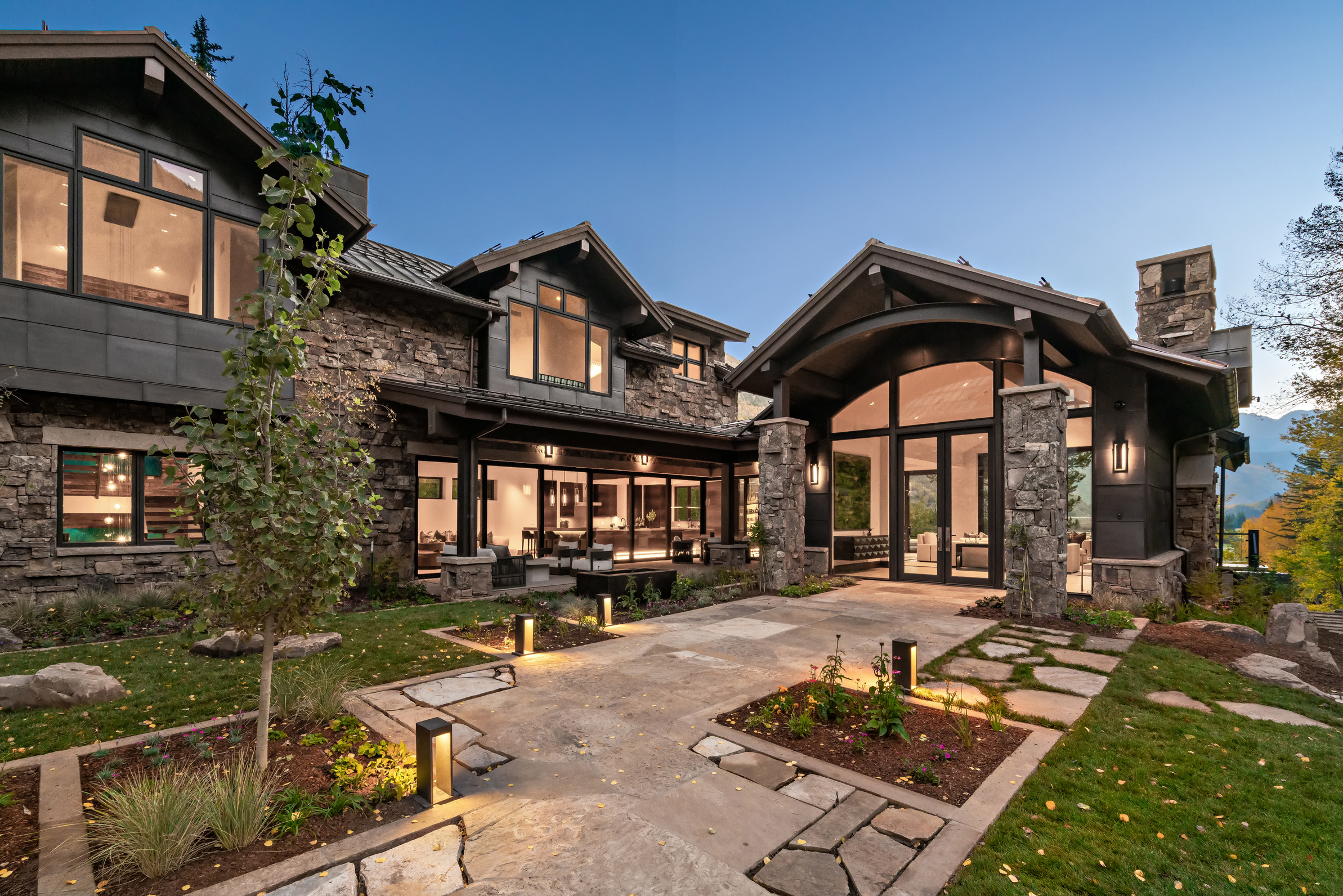 Stone craftsman home entry at dusk